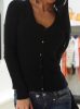 Gombos kötött fekete kardigán hátán masnival